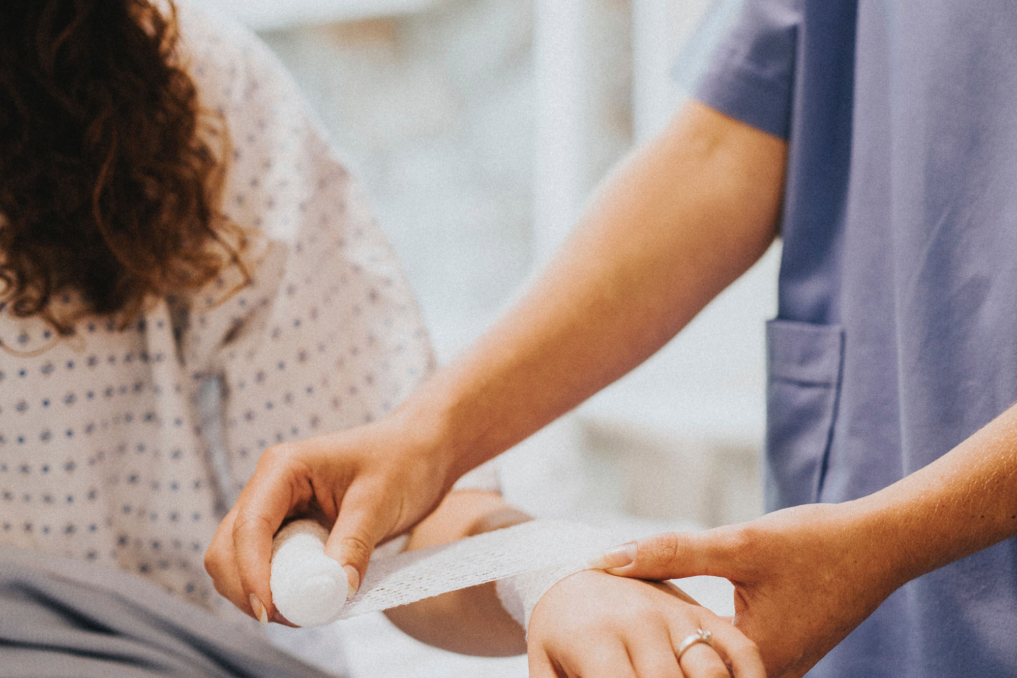 Doctor bandaging patient